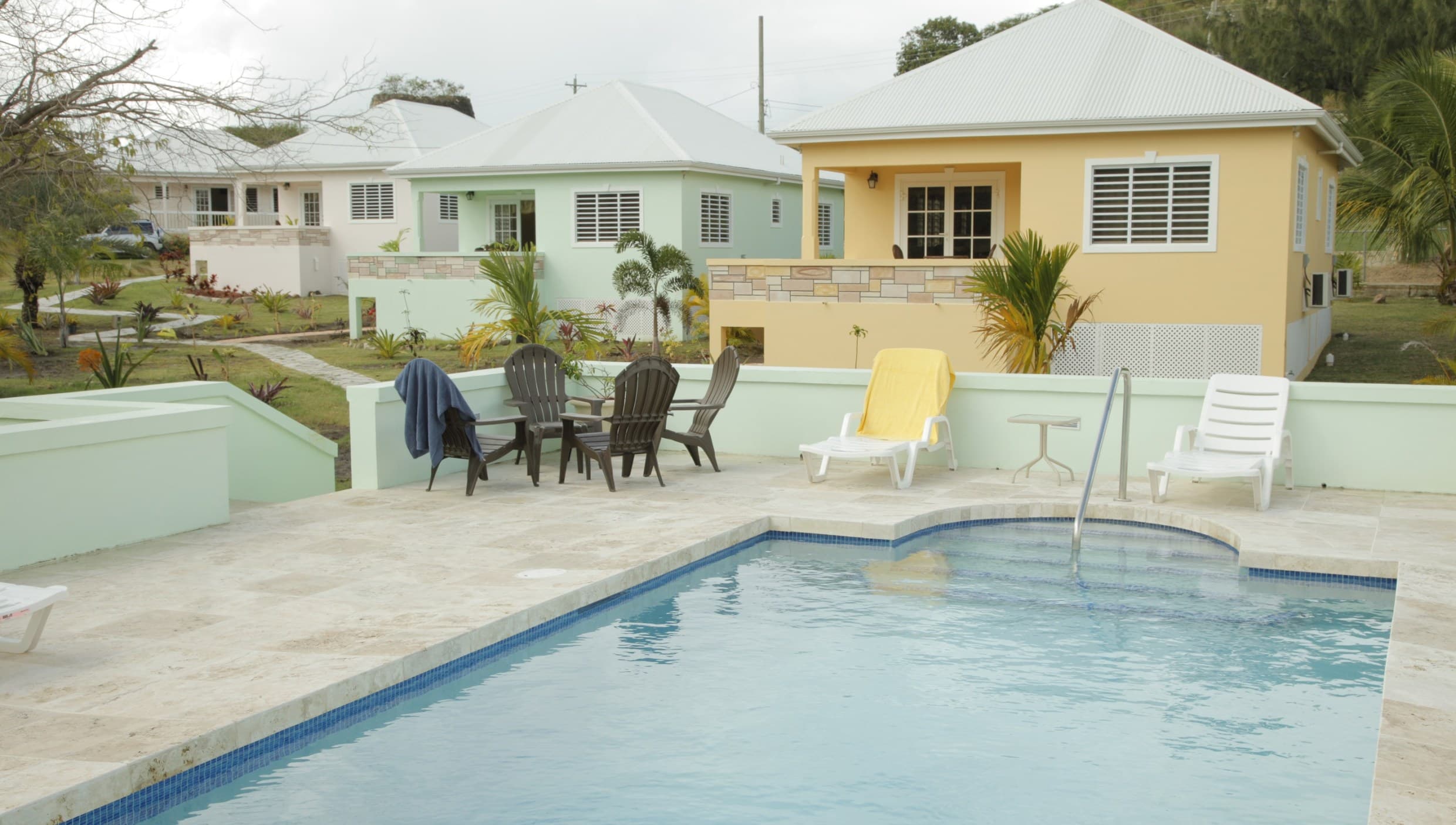 Pastel villas and a pool at Ffryes Estate, Antigua